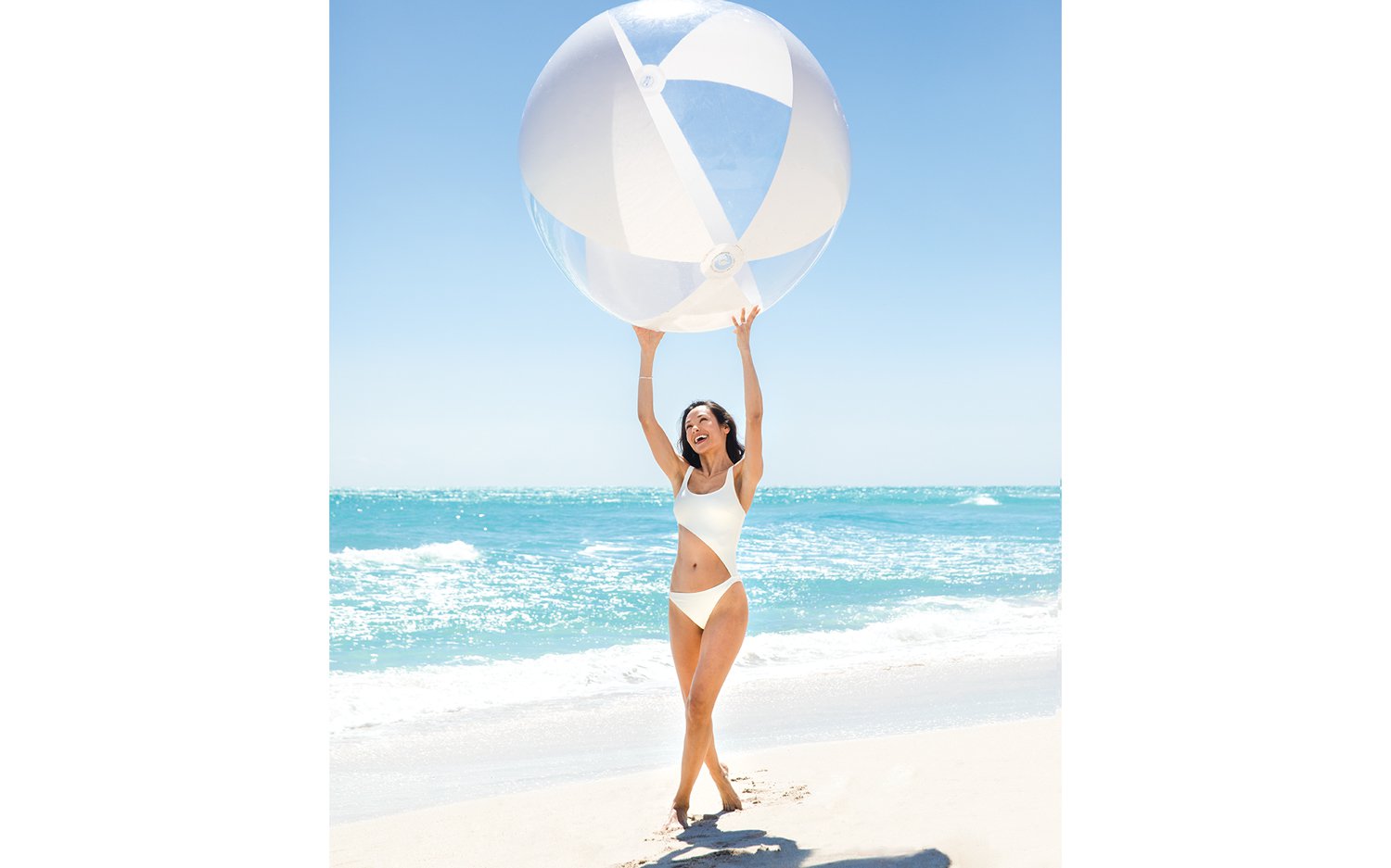 Jacober Creative Brand Identity for The Town of Surfside - Photo woman holding a large beach ball over her head