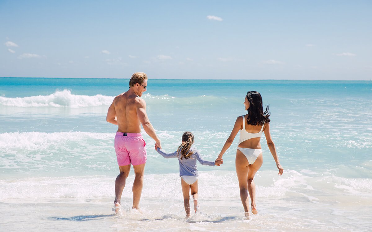 Jacober Creative Brand Identity for The Town of Surfside - Photo of family holding hands running towards the beach